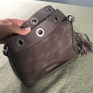 Suede MK crossbody with thick grommet strap.